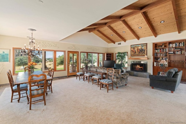 carpeted dining area featuring beam ceiling, a chandelier, high vaulted ceiling, and a tile fireplace