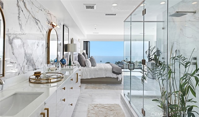 bathroom with vanity, an enclosed shower, and a water view