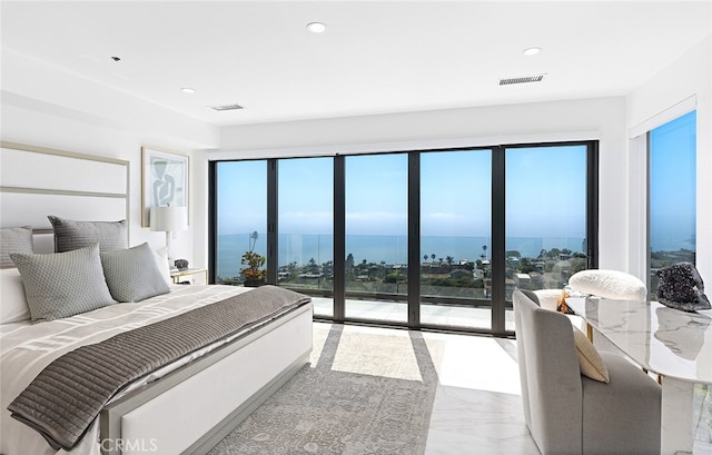 bedroom with a water view, access to outside, and multiple windows