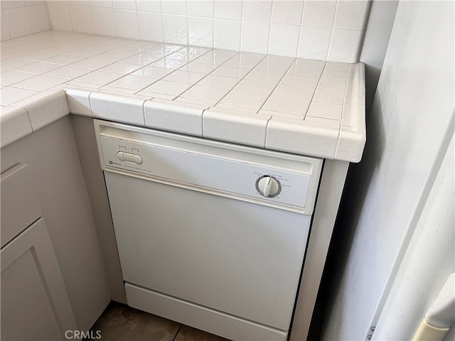 room details featuring white dishwasher and tile counters