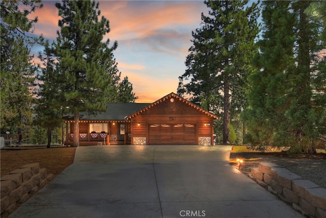 log home featuring a garage