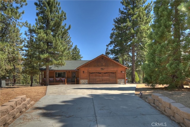 log-style house featuring a garage