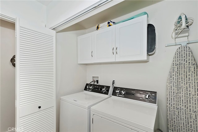 washroom featuring cabinets and washer and dryer