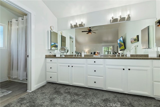 bathroom featuring vanity, lofted ceiling, ceiling fan, hardwood / wood-style flooring, and a shower with curtain