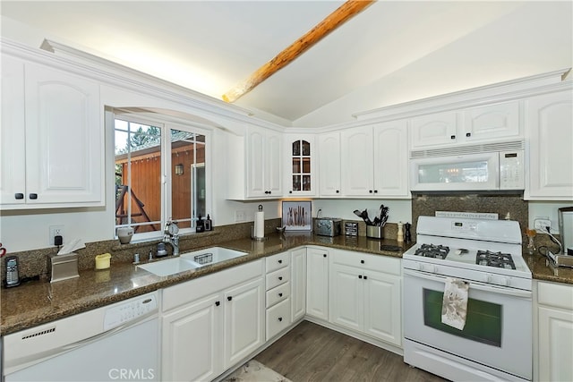 kitchen featuring lofted ceiling, sink, white appliances, and white cabinetry