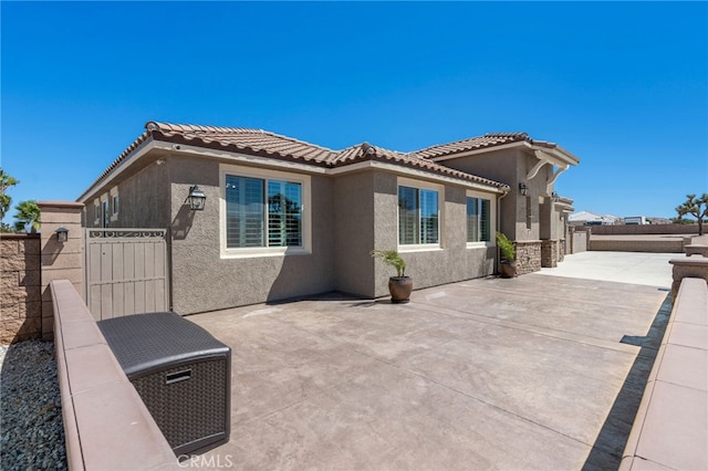 back of property with a patio