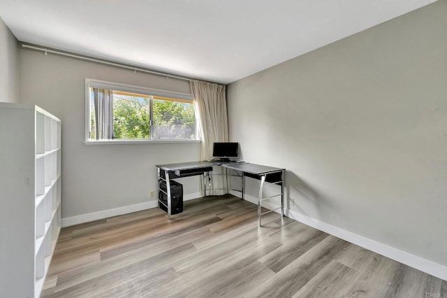 unfurnished office with light wood-type flooring