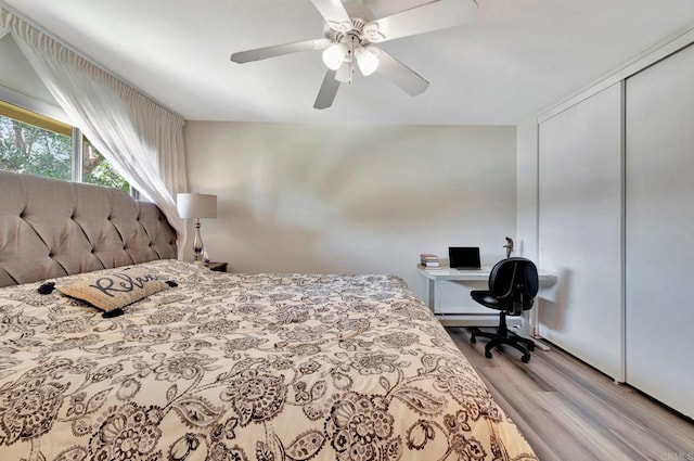 bedroom with ceiling fan, light hardwood / wood-style floors, and a closet