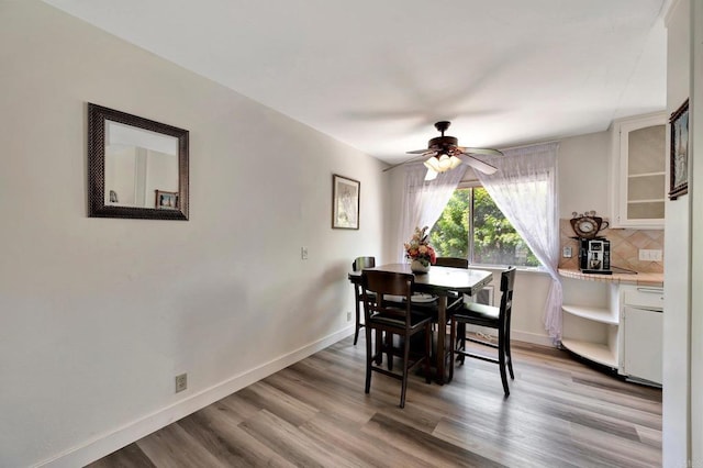 dining room featuring light hardwood / wood-style flooring and ceiling fan