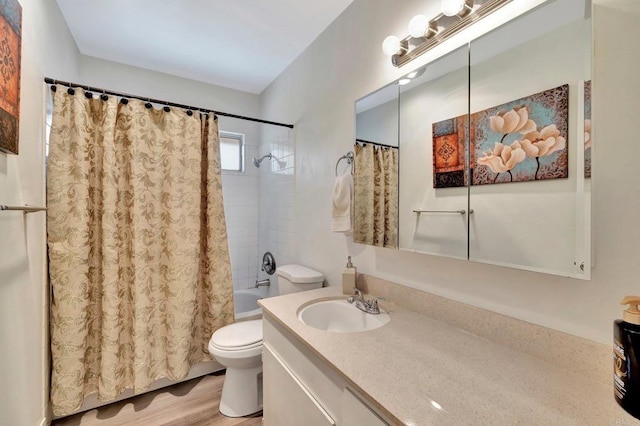 full bathroom with hardwood / wood-style flooring, vanity, toilet, and shower / bath combo with shower curtain