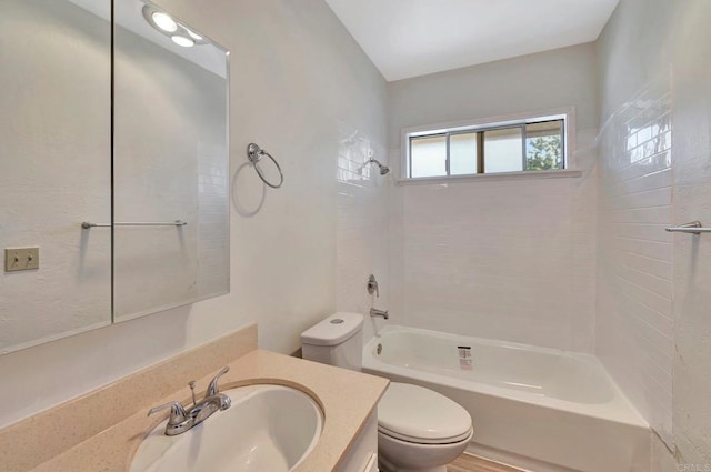 full bathroom featuring tiled shower / bath combo, vanity, and toilet