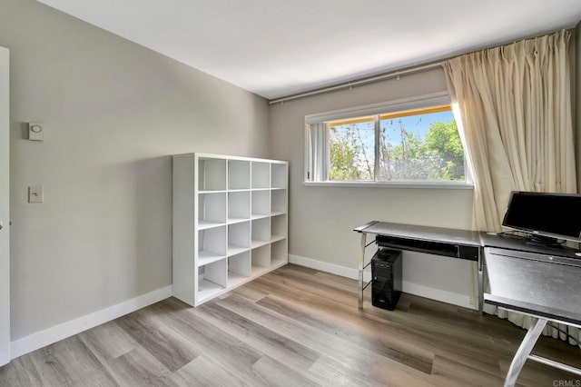 unfurnished office with light wood-type flooring