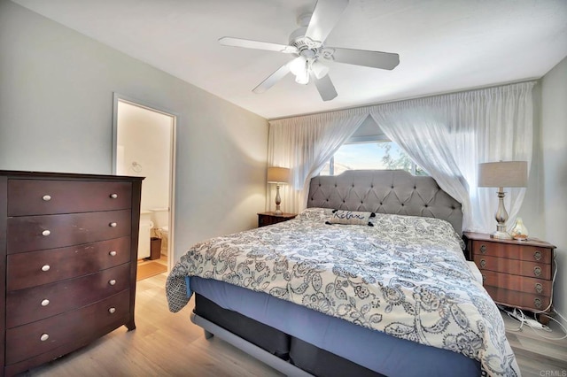 bedroom with ceiling fan, ensuite bath, and light hardwood / wood-style flooring