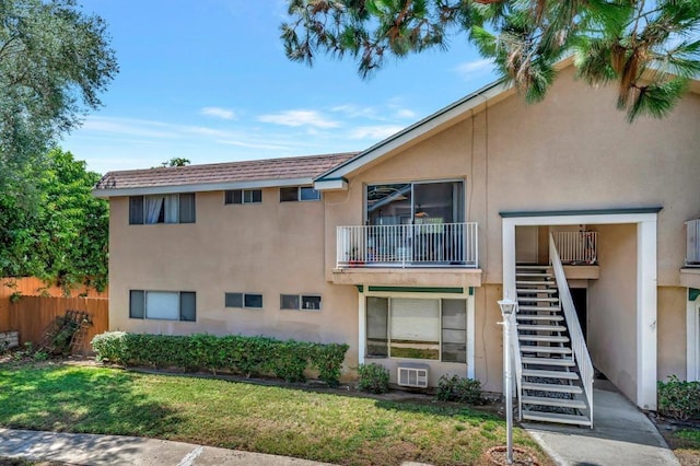 exterior space with stairs, fence, and a wall mounted air conditioner