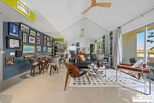 living room with ceiling fan and vaulted ceiling