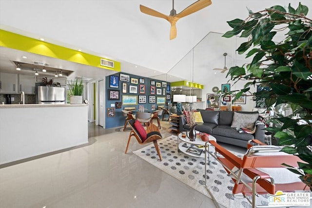 living room with ceiling fan and sink