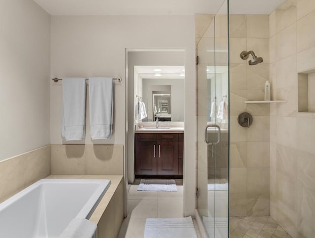 bathroom with tile patterned floors, vanity, and shower with separate bathtub