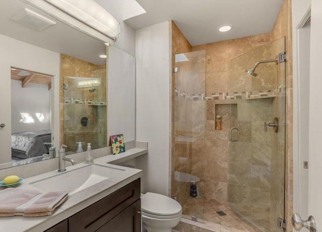 bathroom featuring vanity, an enclosed shower, and toilet