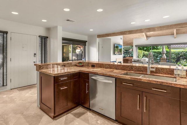 kitchen featuring beamed ceiling, dishwasher, light stone countertops, and sink