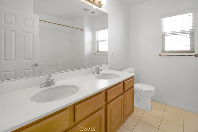 bathroom with walk in shower, tile patterned flooring, vanity, and toilet