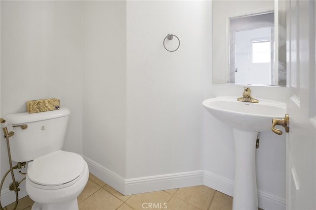 bathroom featuring tile patterned flooring and toilet