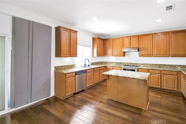 kitchen with light stone counters, a kitchen island, stainless steel dishwasher, crown molding, and dark hardwood / wood-style flooring