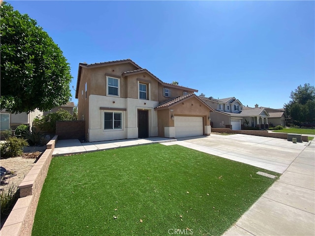 mediterranean / spanish-style home with a front lawn and a garage