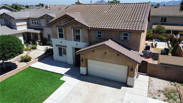 view of front facade featuring a front yard and a garage