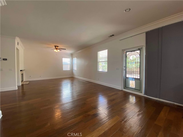 unfurnished living room featuring ornamental molding, ceiling fan, plenty of natural light, and dark wood-type flooring