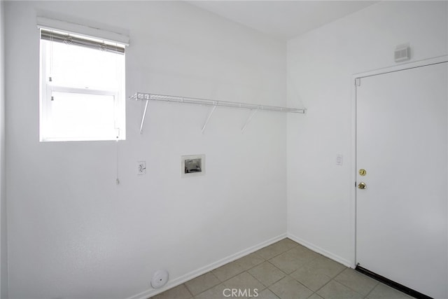 washroom with washer hookup and light tile patterned flooring