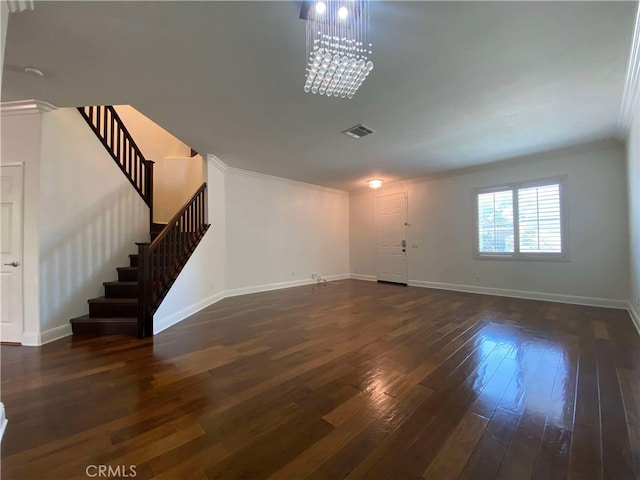 unfurnished living room with ornamental molding, a chandelier, and dark hardwood / wood-style floors