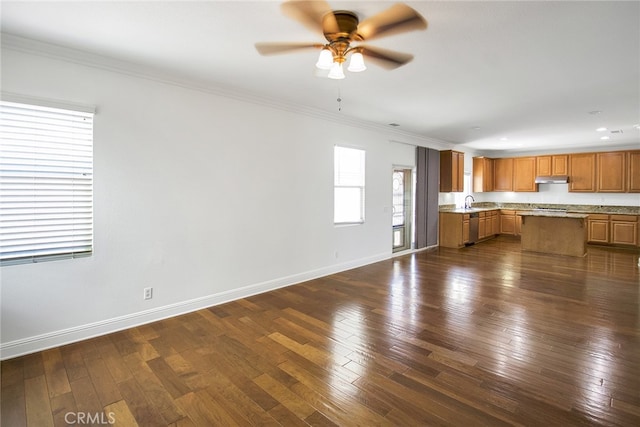 unfurnished living room with ceiling fan, dark hardwood / wood-style floors, and crown molding