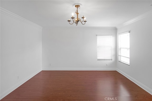 empty room featuring ornamental molding, a chandelier, and dark wood-type flooring