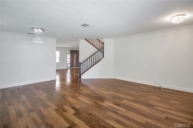 spare room with an inviting chandelier, a textured ceiling, ornamental molding, and dark hardwood / wood-style flooring