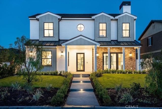 modern farmhouse featuring a front lawn