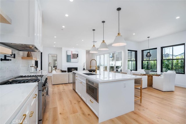 kitchen featuring sink, white cabinets, plenty of natural light, and appliances with stainless steel finishes