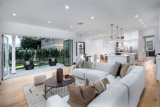 living room featuring light hardwood / wood-style flooring and sink