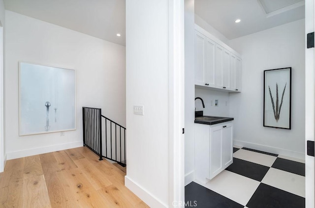 washroom with sink and light hardwood / wood-style flooring