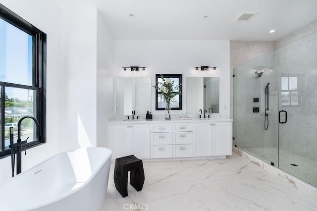 bathroom with separate shower and tub, vanity, and a healthy amount of sunlight