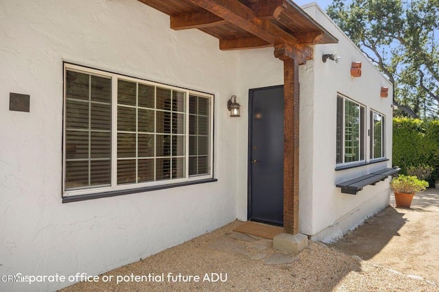 property entrance with stucco siding