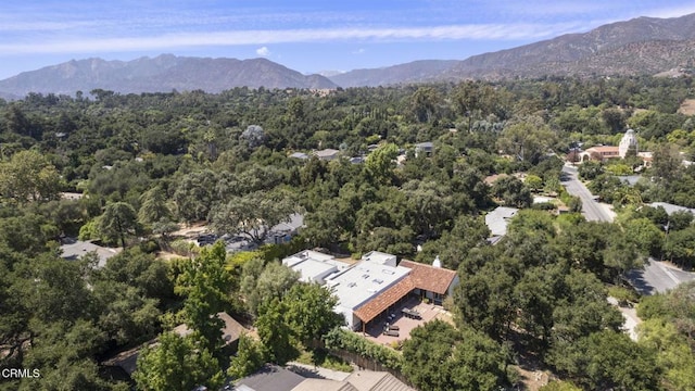 aerial view with a mountain view and a view of trees