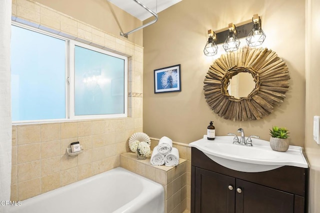 full bathroom with a bath and vanity