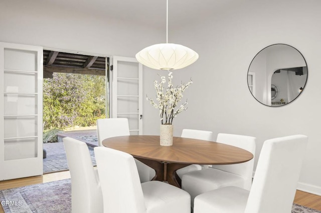 dining area with wood finished floors