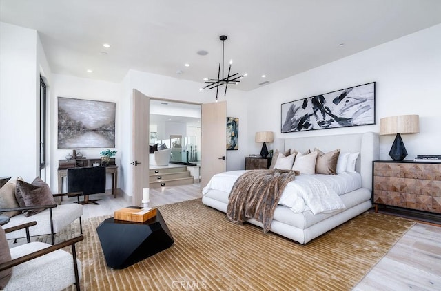 bedroom with a chandelier and light wood-type flooring