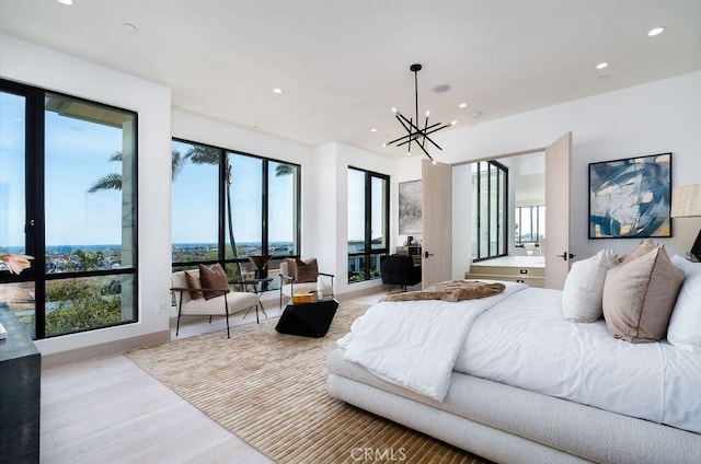 bedroom featuring an inviting chandelier, access to exterior, and light hardwood / wood-style flooring