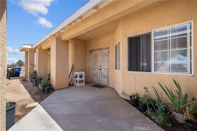 doorway to property with a patio area