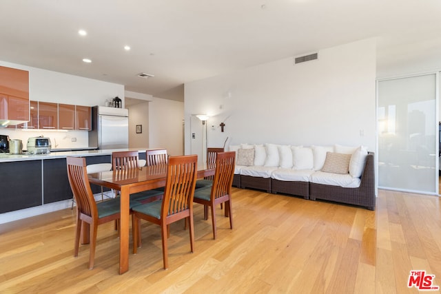 dining space with light wood-type flooring