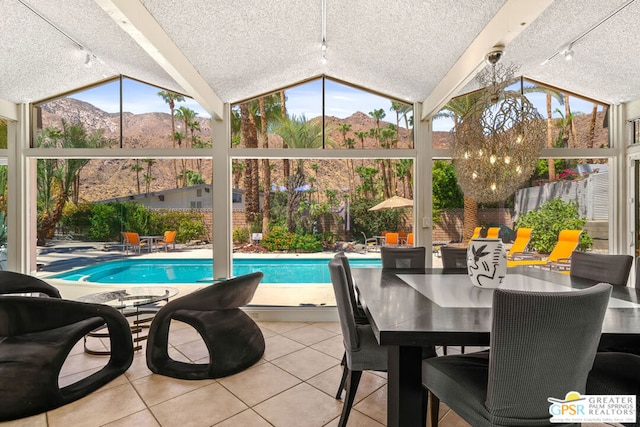 view of swimming pool with a mountain view and a patio