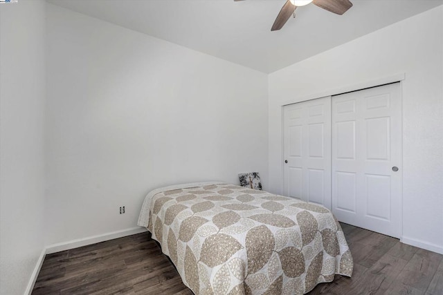 bedroom with dark hardwood / wood-style flooring, a closet, and ceiling fan