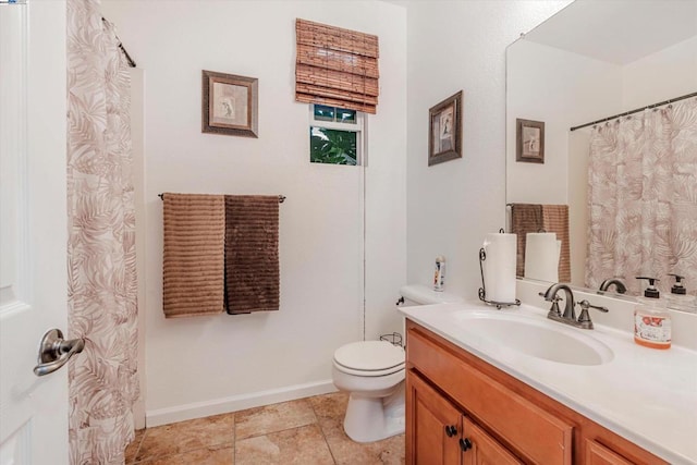 bathroom with vanity, tile patterned floors, and toilet